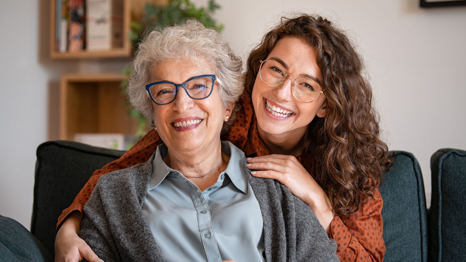 An older and a younger woman smiling and relaxed together.